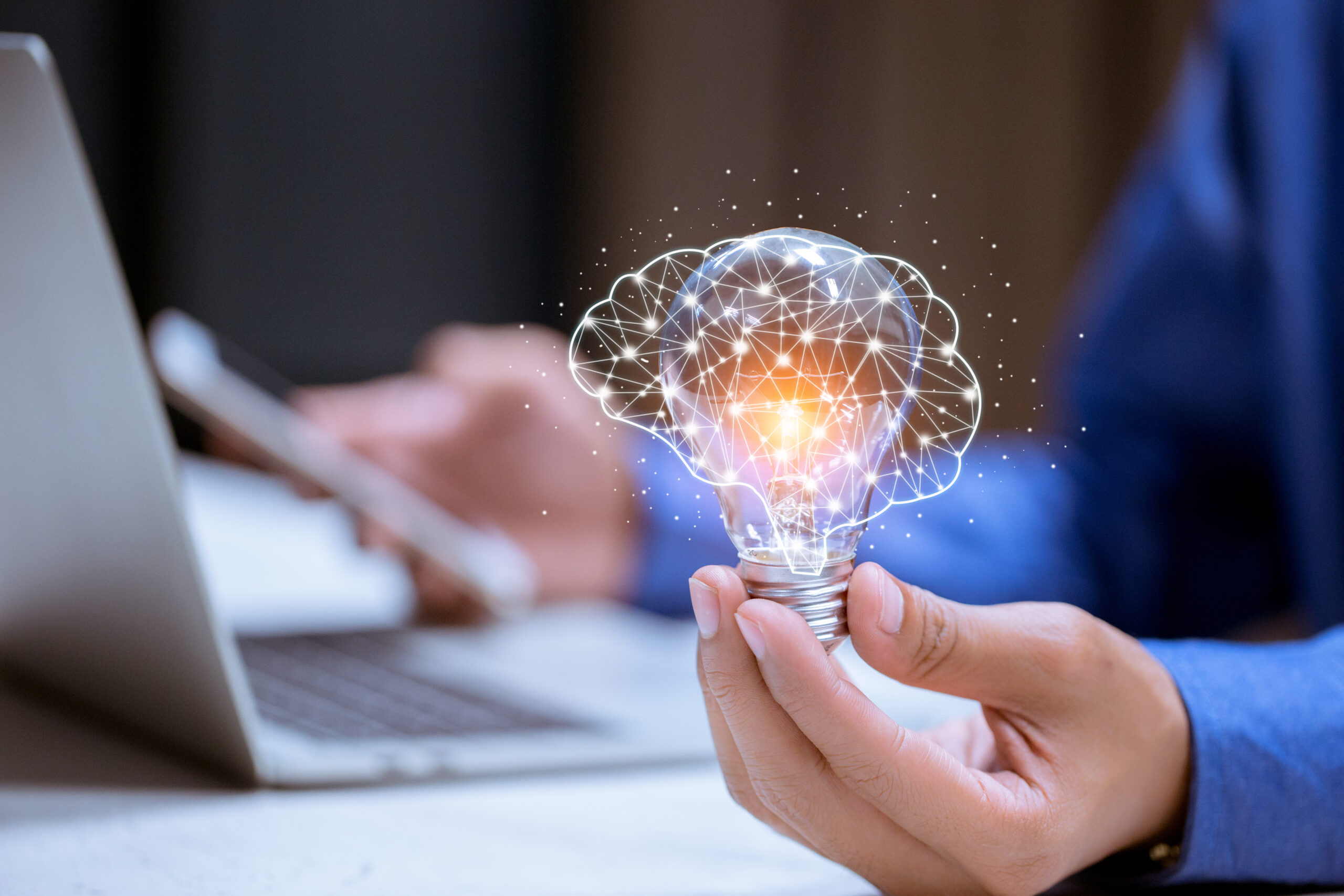 Business hand holding light bulb,with brain icon,creativity and innovative are keys to success,new ideas and innovation concept.